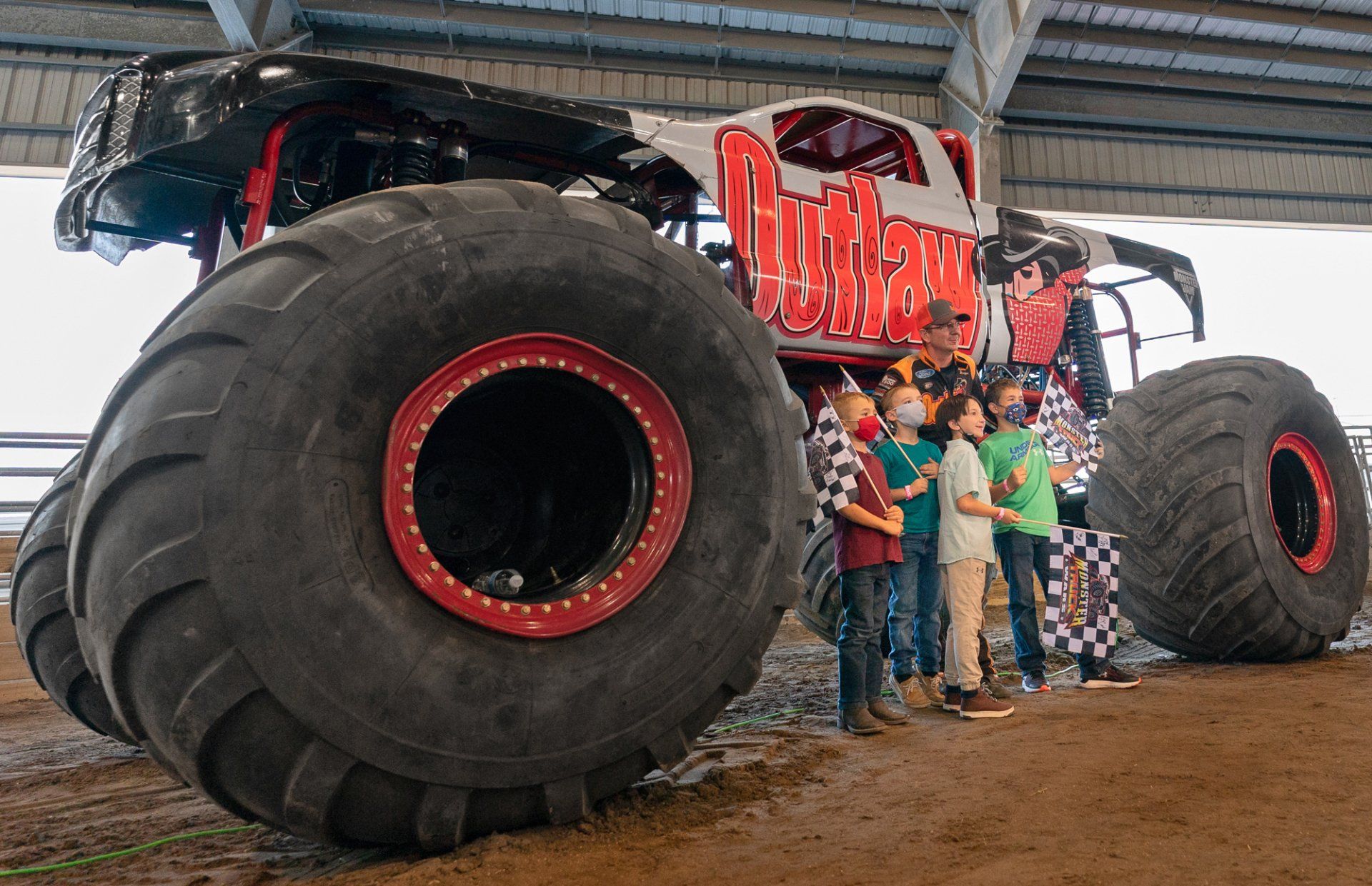 Kids standing in front of a monster truck