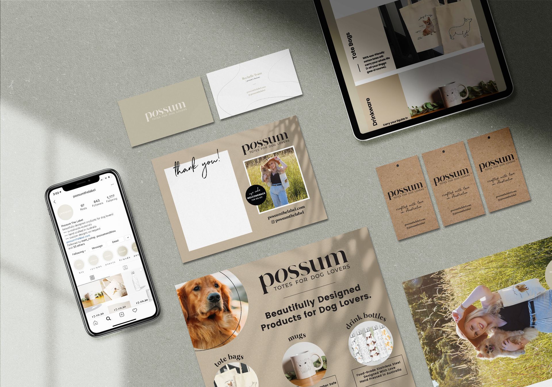 A phone , tablet , business cards , and flyers are sitting on a table.