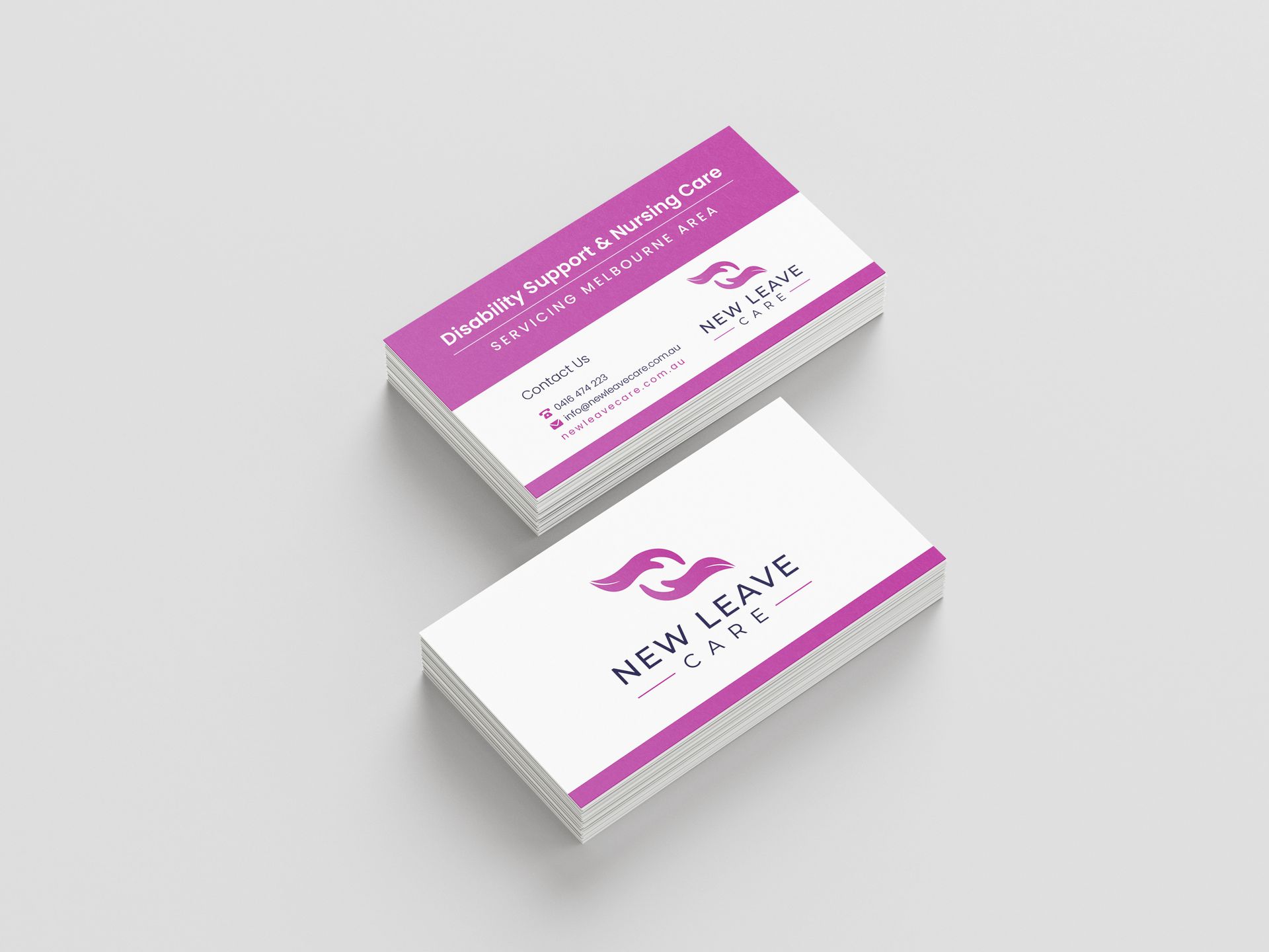 Two business cards are stacked on top of each other on a white surface.