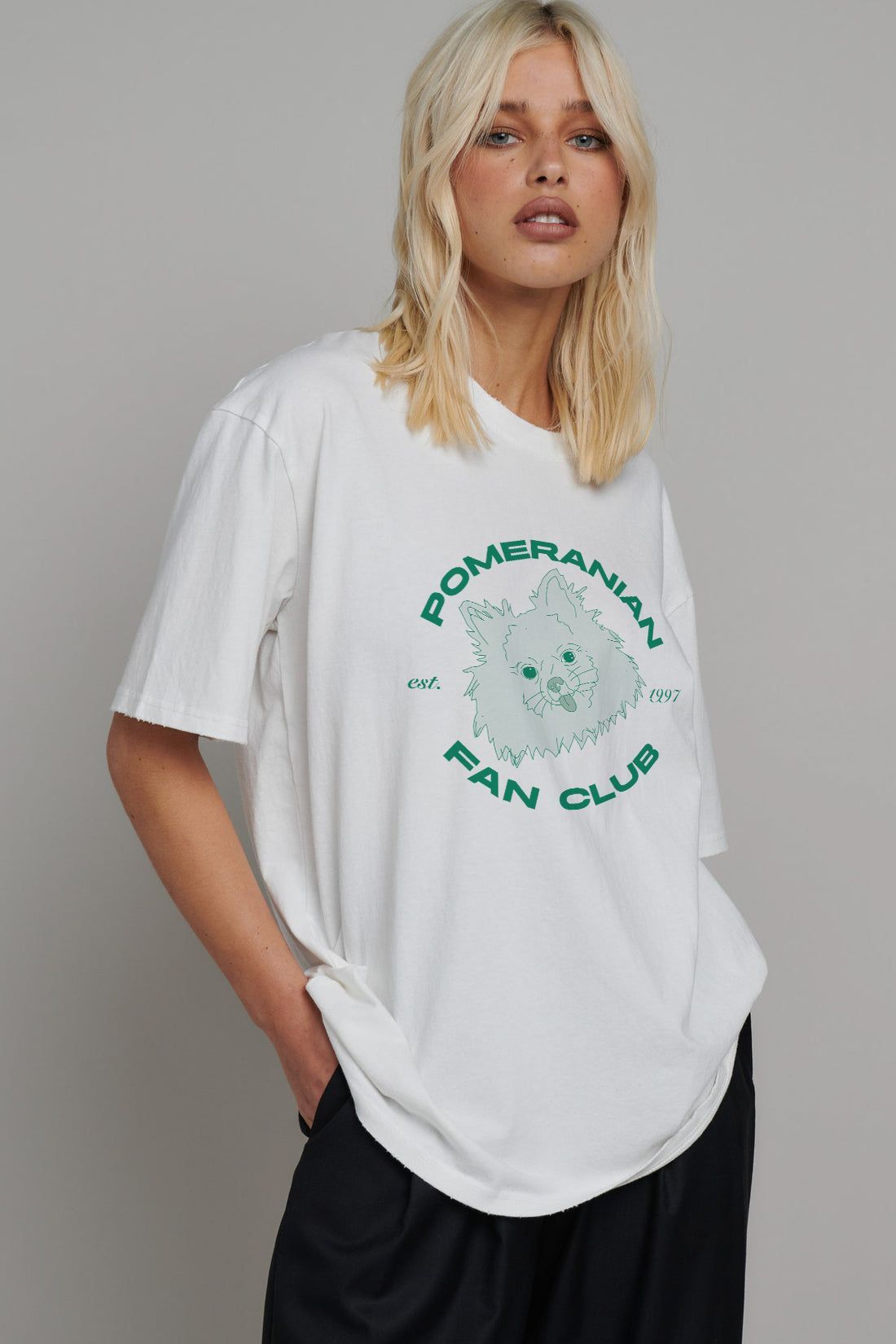 A woman is wearing a white t-shirt with a pomeranian on it.