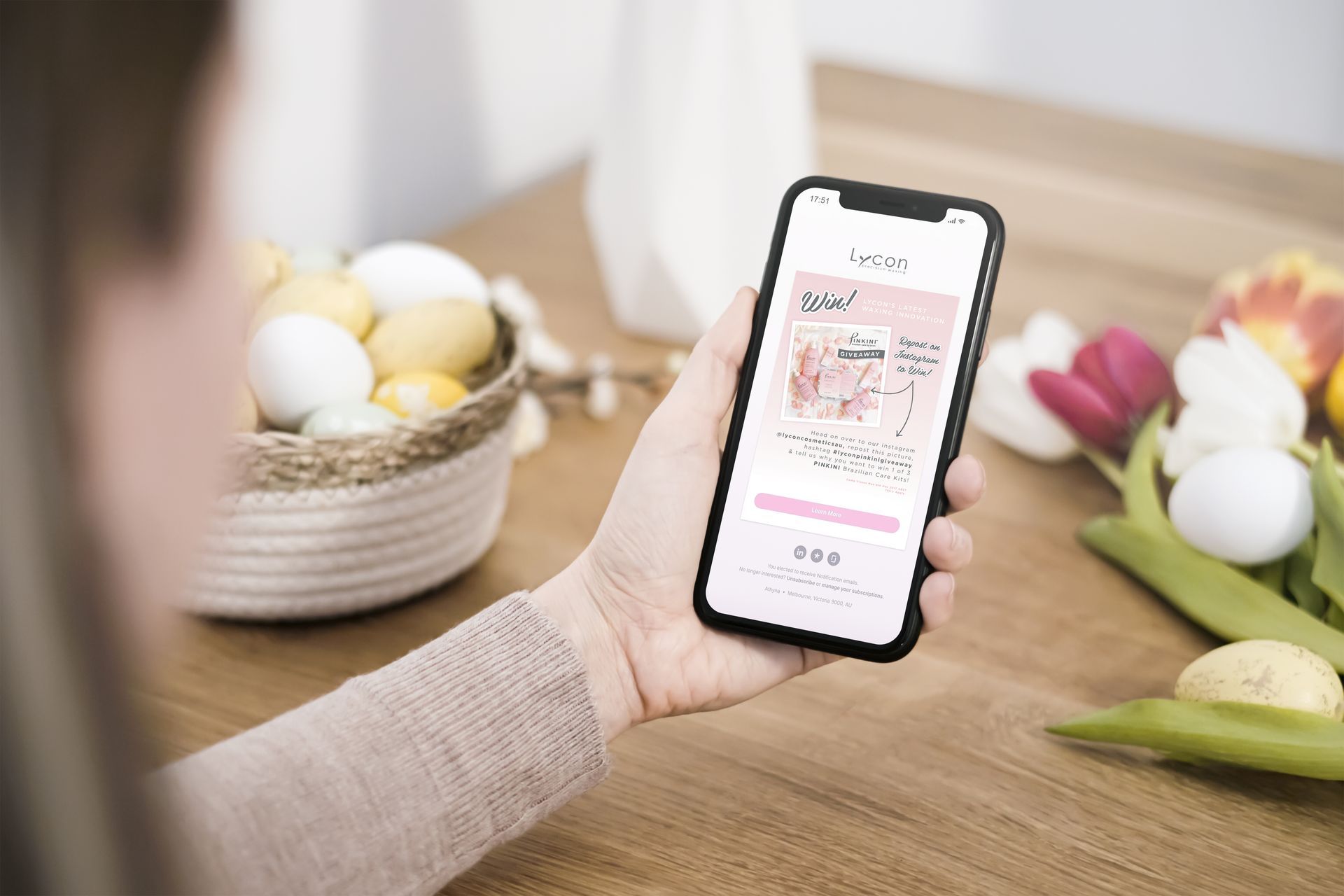 A woman is holding a cell phone in her hand.