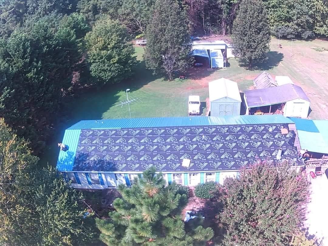 An aerial view of a house with solar panels on the roof