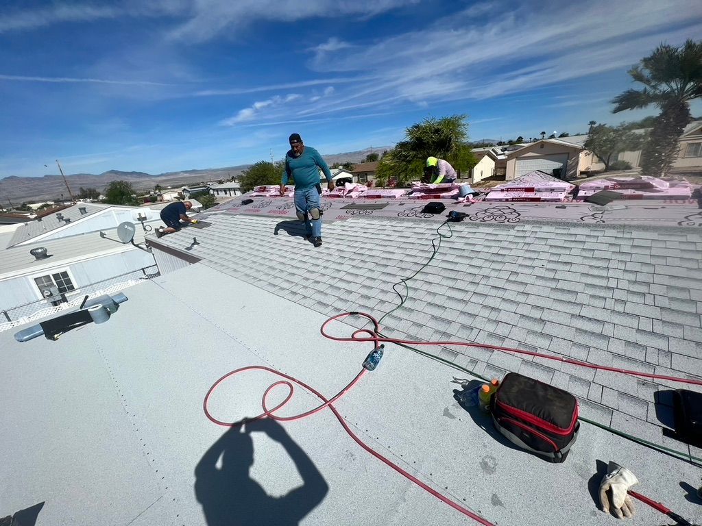 Two men are working on the roof of a house.