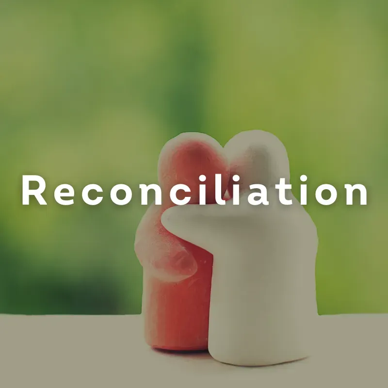 Two small figurines embracing, one red and one white, with “Reconciliation” over a green background.
