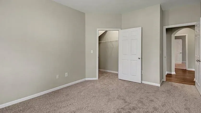 Empty bedroom with closet and hallway access at Woodland Pointe in Nashville, TN.