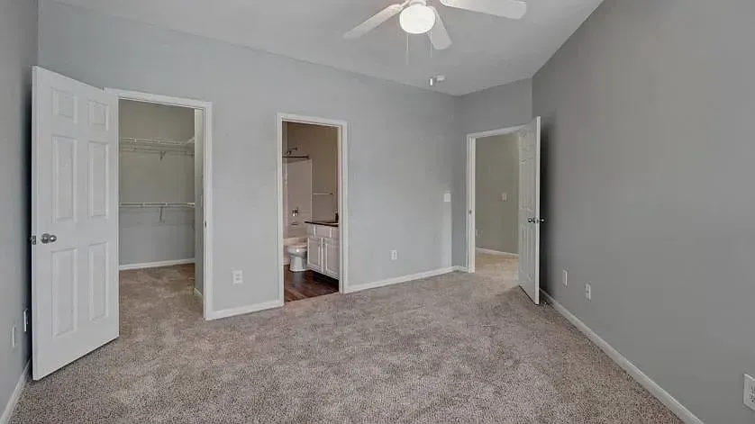 Spacious bedroom with a walk-in closet and en-suite bathroom at Woodland Pointe in Nashville, TN.