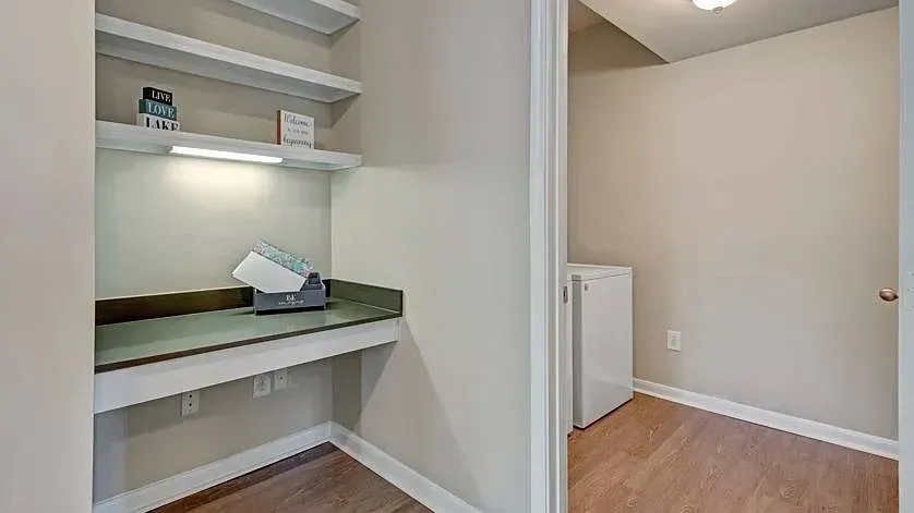 Built-in desk with shelves and a washer/dryer closet at Woodland Pointe in Nashville, TN.