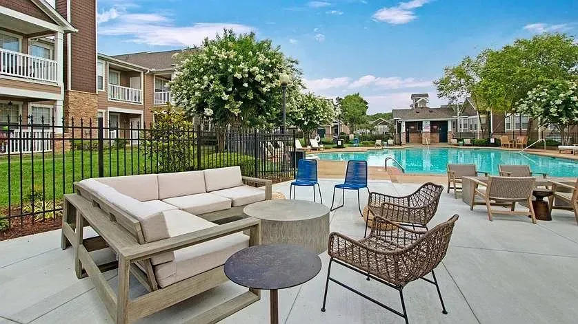 Outdoor pool area with lounge seating and fire pit at Woodland Pointe in Nashville, TN.