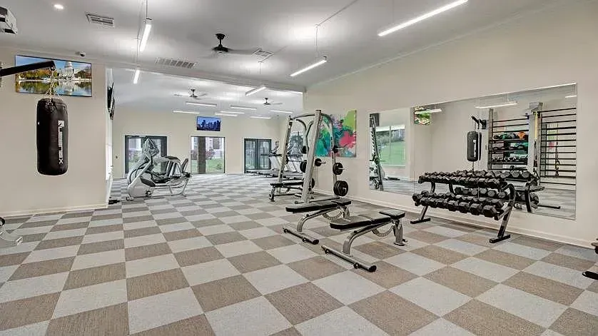 Well-equipped fitness center with cardio machines, free weights, and a punching bag at Woodland Pointe in Nashville, TN.