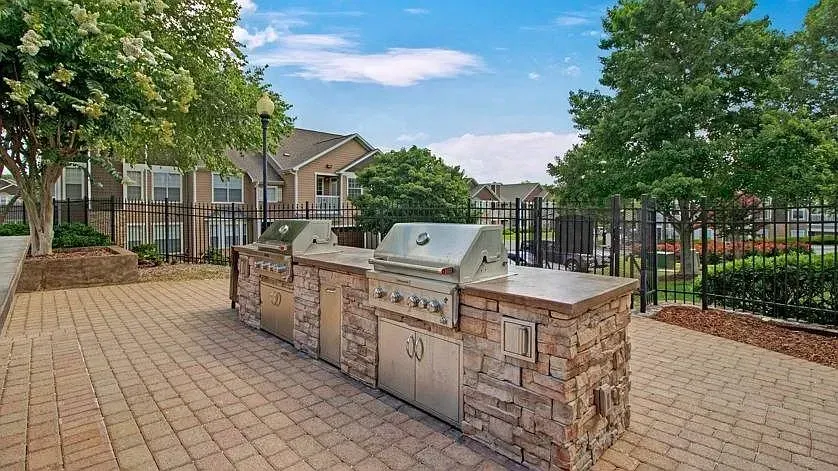 Outdoor kitchen with two built-in grills on a paved patio at Woodland Pointe in Nashville, TN.