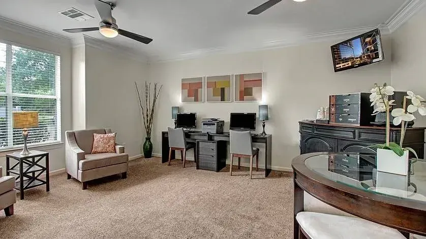 Business center with two computer workstations, a printer, and a seating area at Woodland Pointe in Nashville, TN.