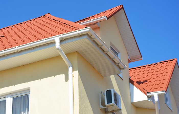 A house with a red tiled roof and a white gutter