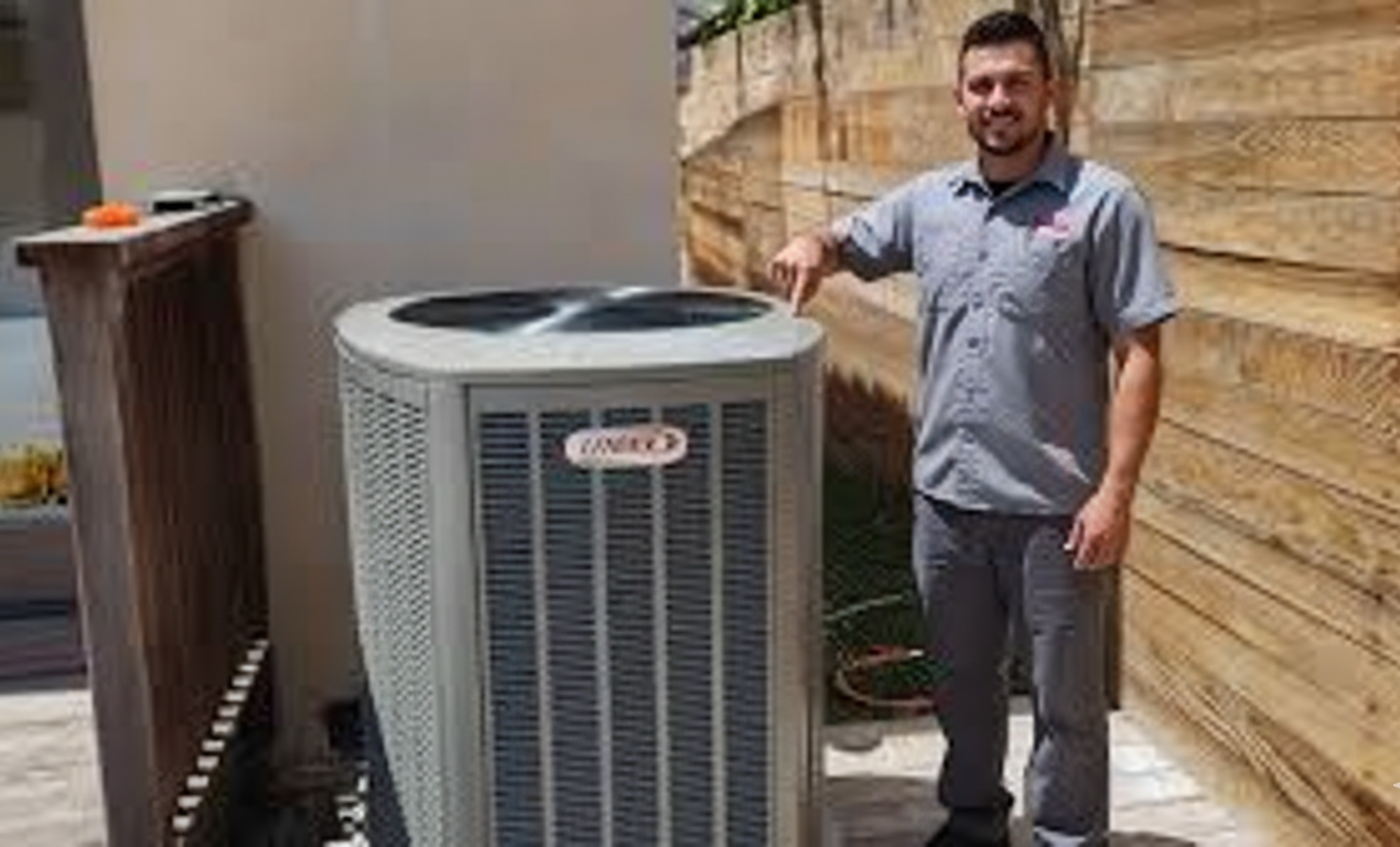 Man in uniform points to an outdoor Lennox air conditioning unit in a yard.