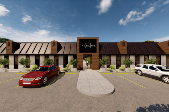 A red car is parked in front of a rendering of The Square office building in Covington, LA