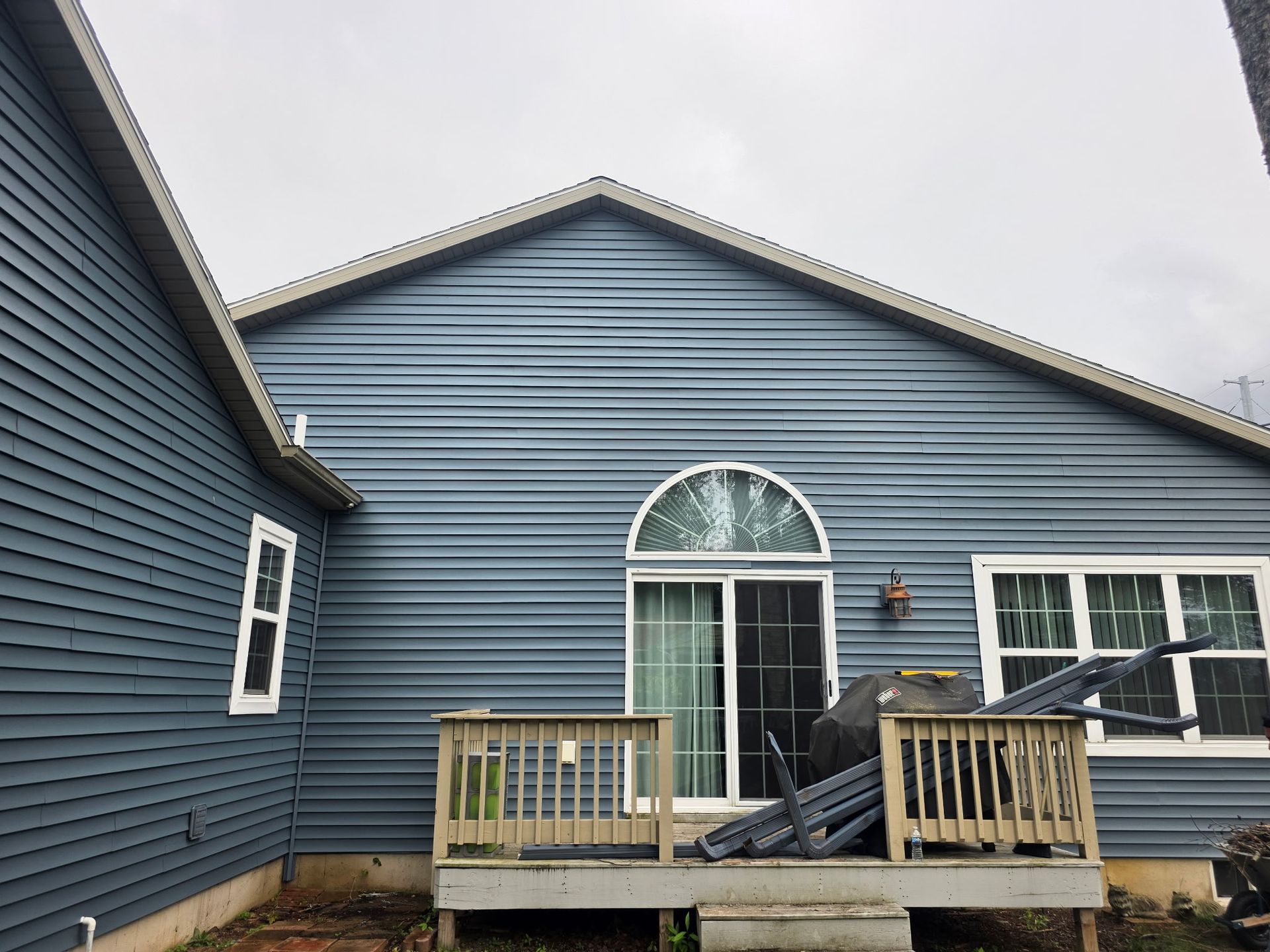 Back of a house with blue vinyl siding installation in Gaylord, MI.