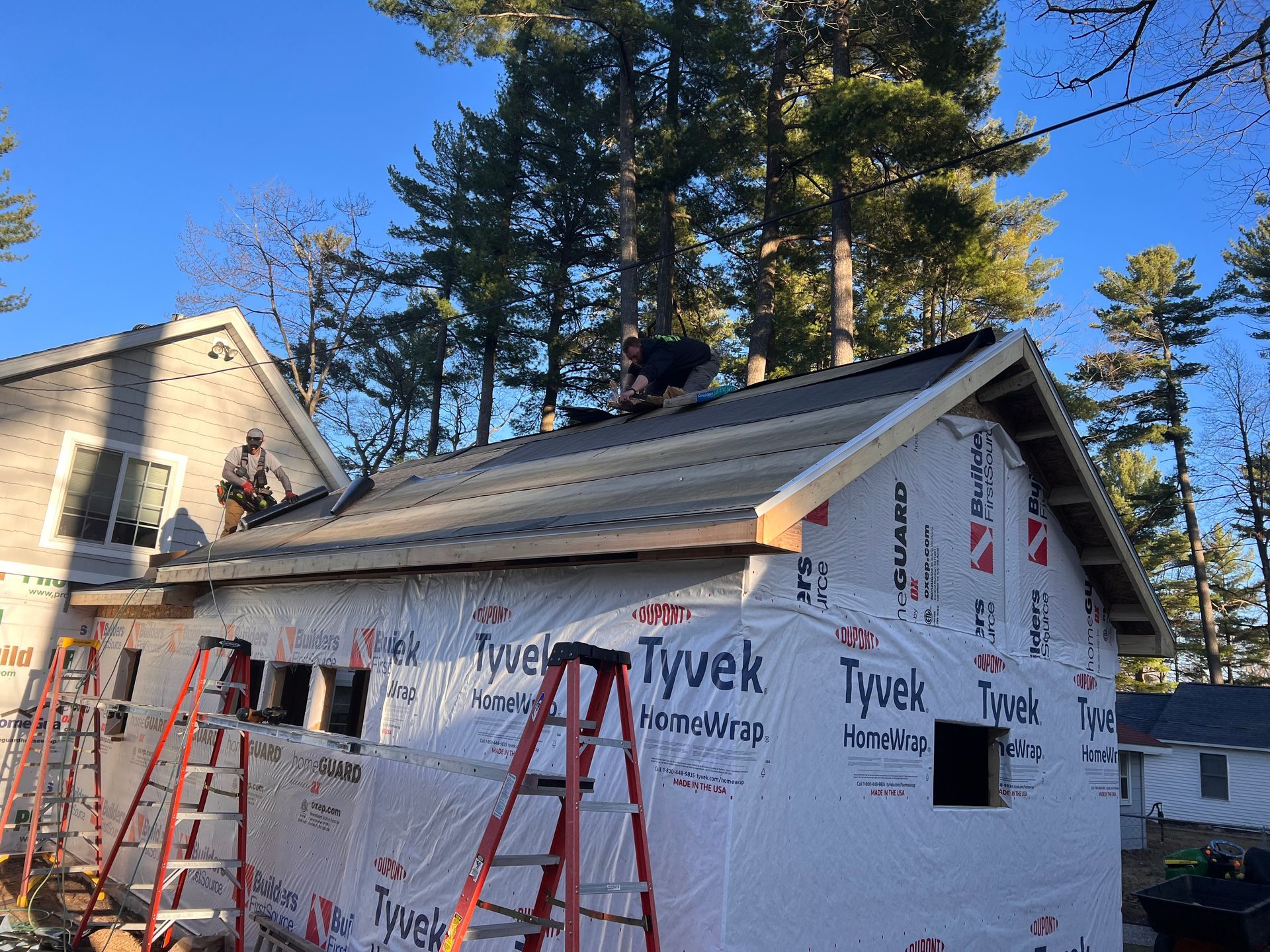 Alpine Brothers Construction team working on a siding replacement and roof replacement project.
