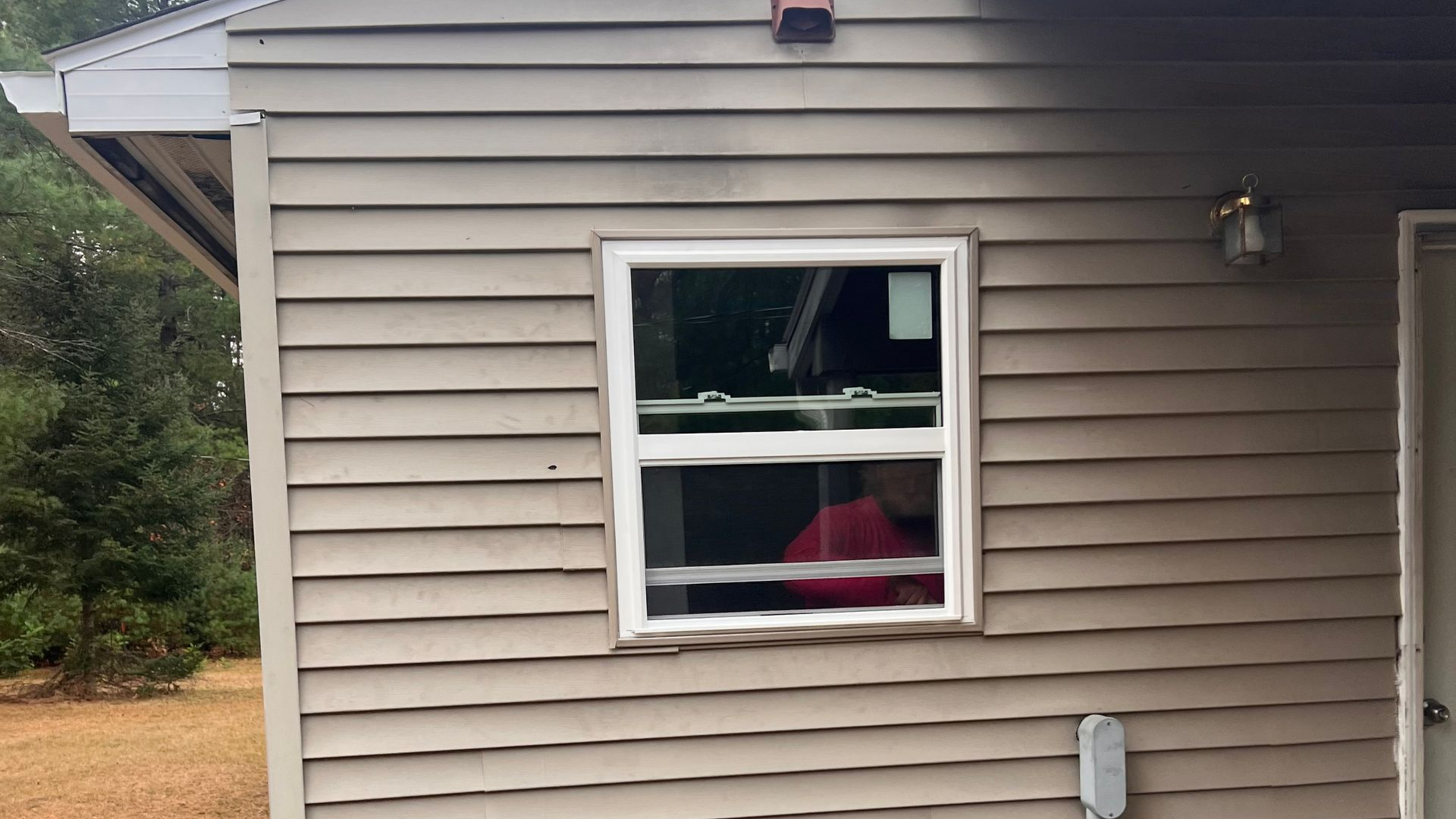 A closeup image of a square window installation by Alpine Brothers Construction