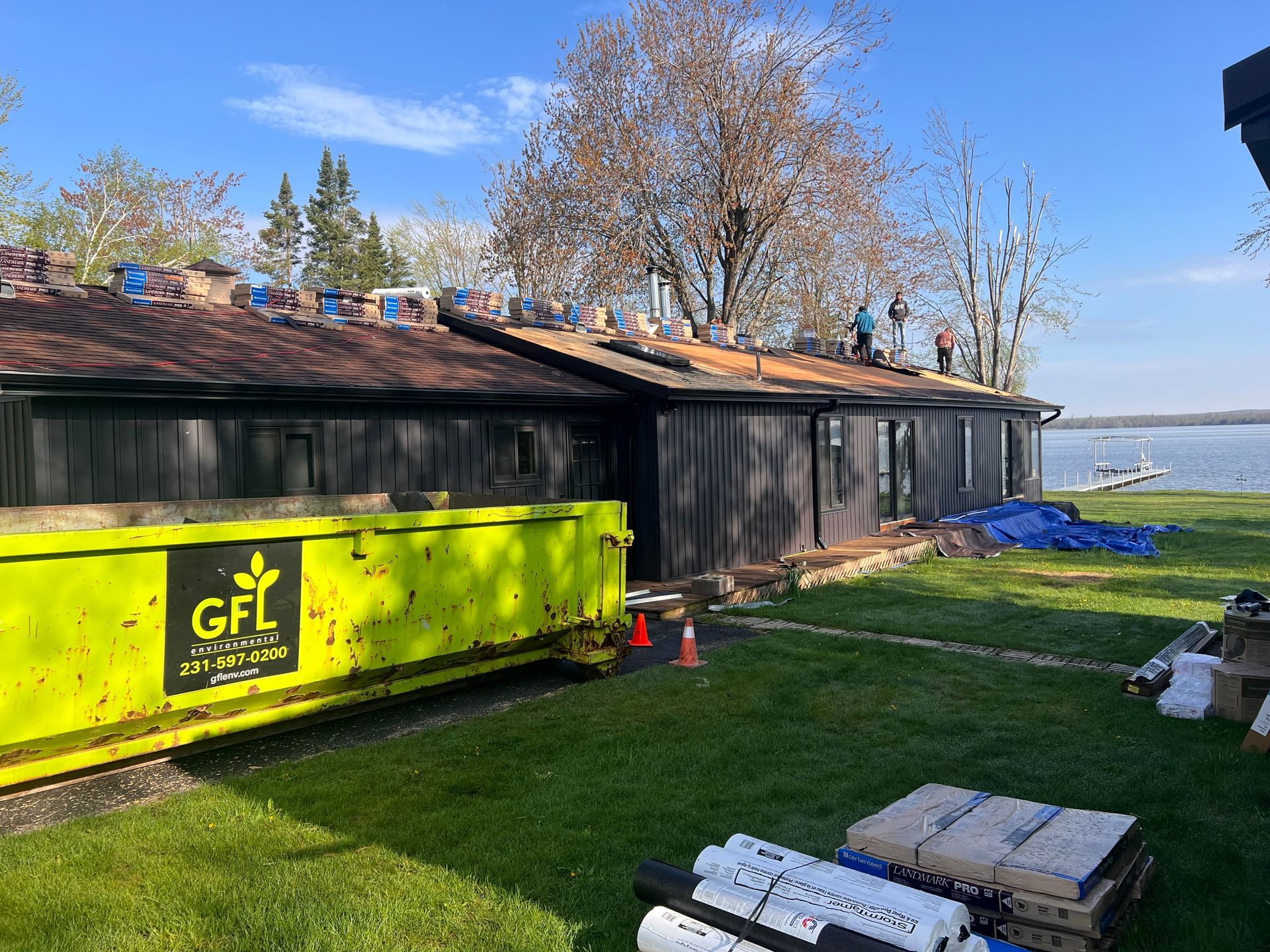 Alpine Brothers Construction team installing a brown asphalt shingle roof 