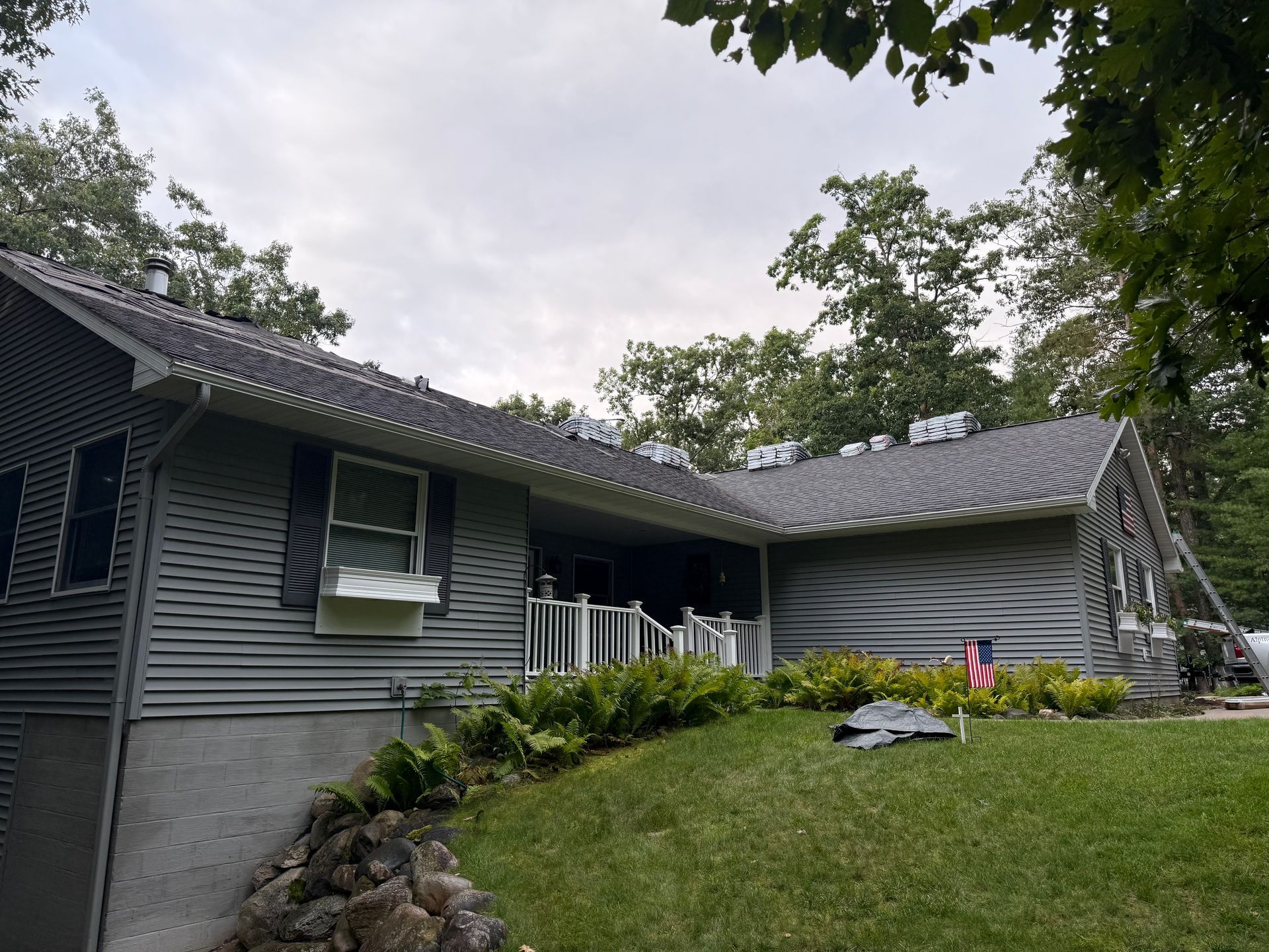 House with a nearly complete asphalt shingle replacement