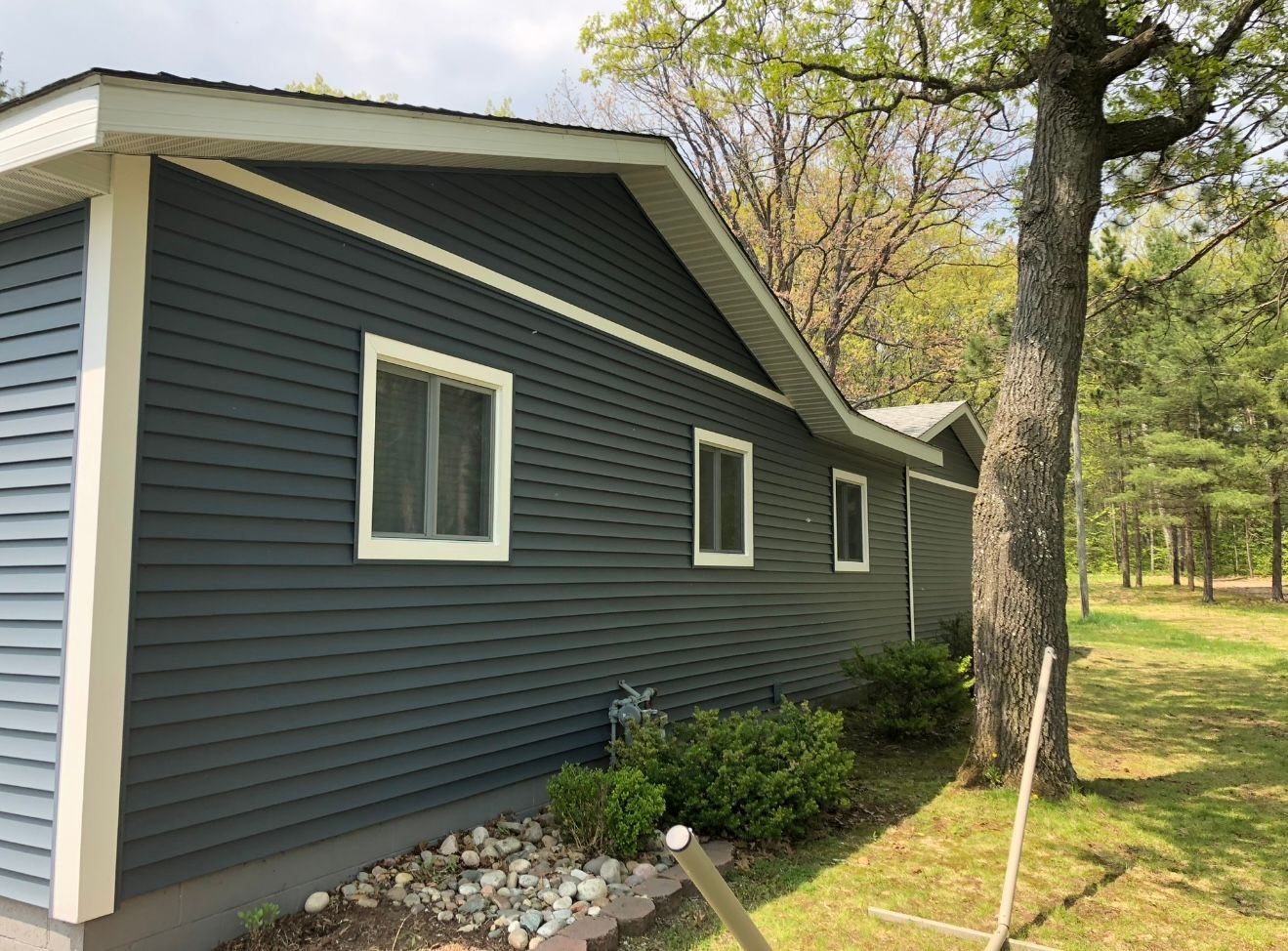 House with blue grey vinyl siding installation by Alpine Brothers Construction