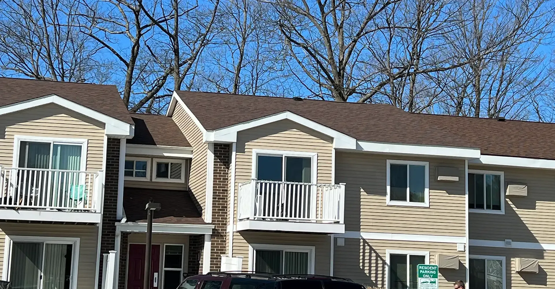 Apartment building with new vinyl siding and asphalt shingle roofing