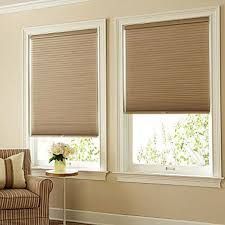 A close up of a black roller blind on a window.