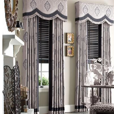 A living room with curtains and a fireplace