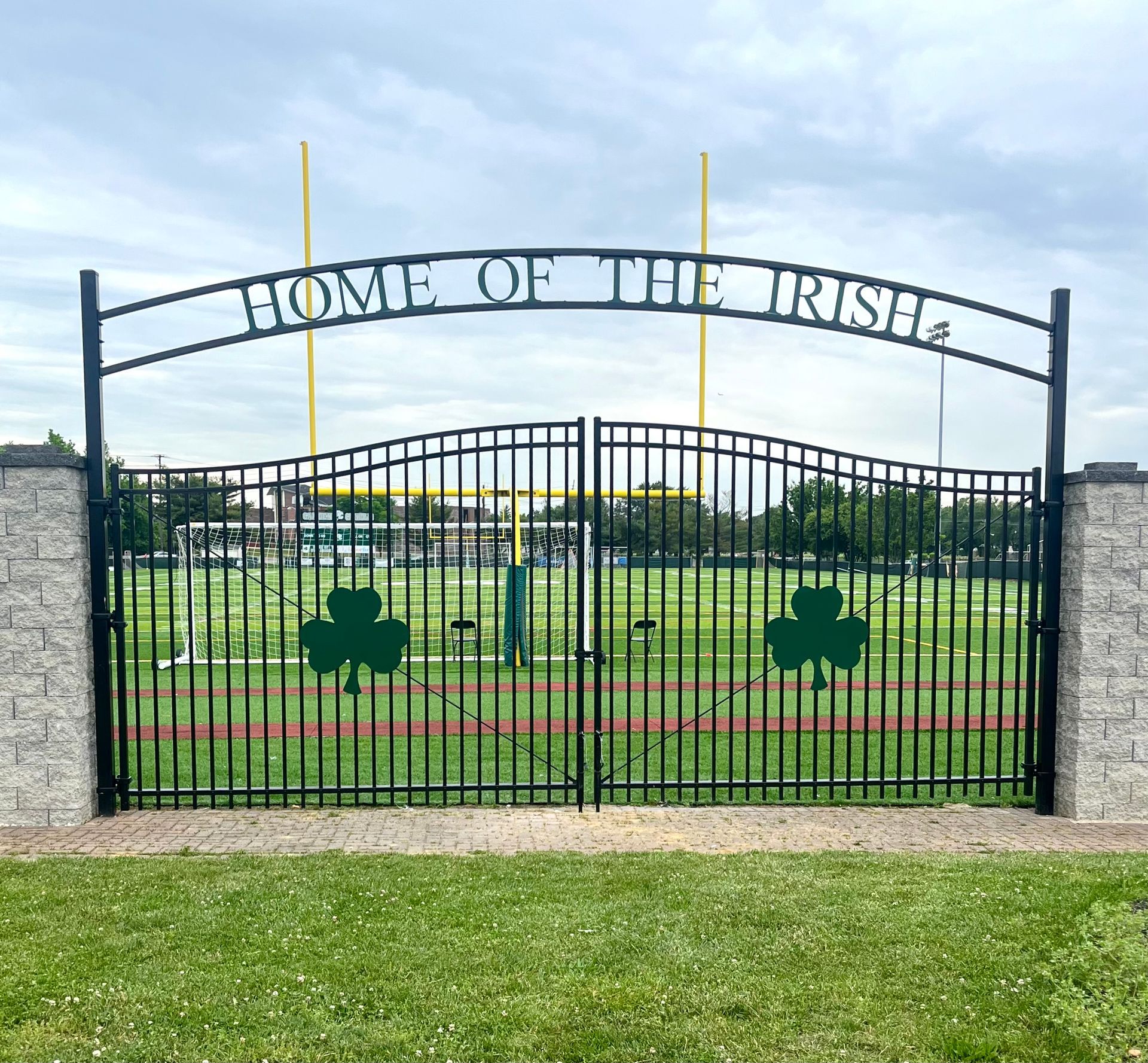 A sliding gate is open in front of a house.