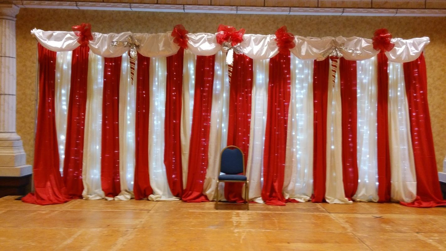 There is a chair in front of a red and white backdrop