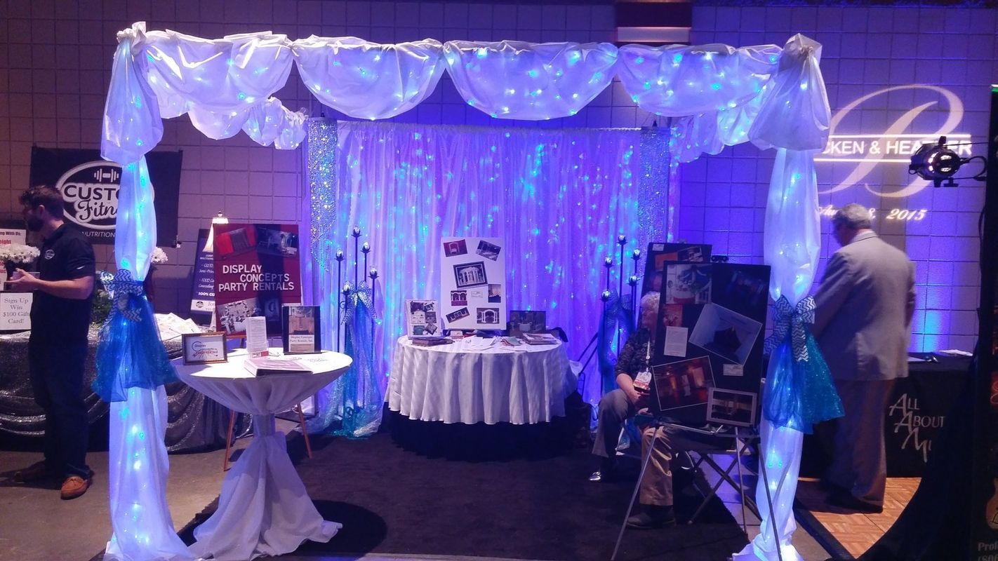 A room with a table and a canopy with lights on it