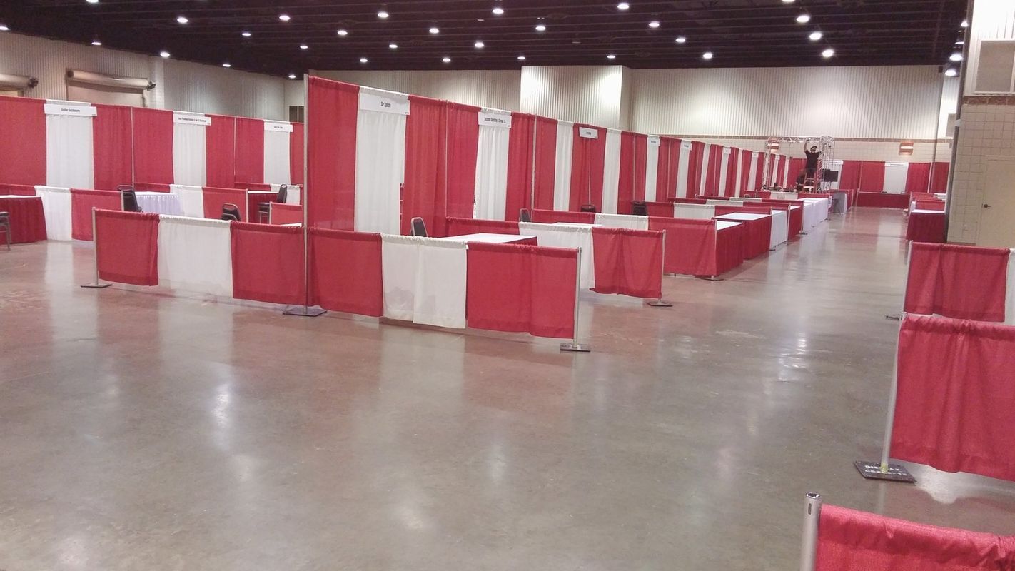 A large room with red and white curtains and tables