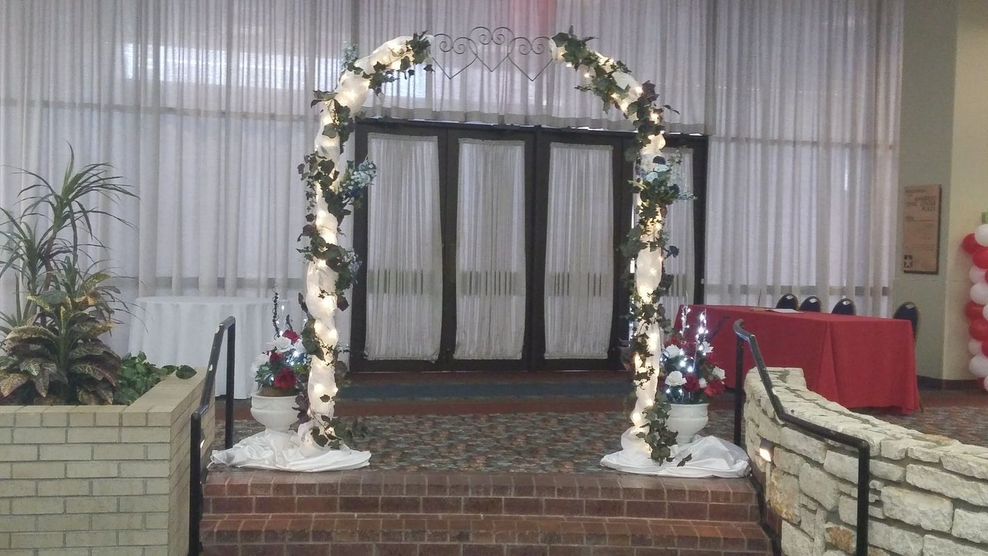 There is a wedding arch in the middle of a room