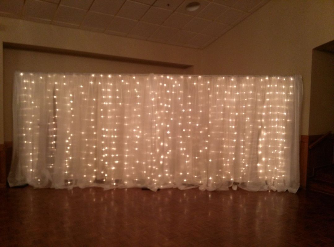 A room with a white curtain with lights on it