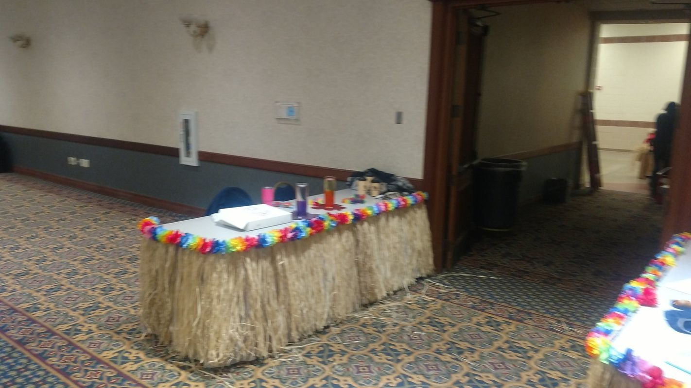 A table with a hawaiian skirt is in a hallway