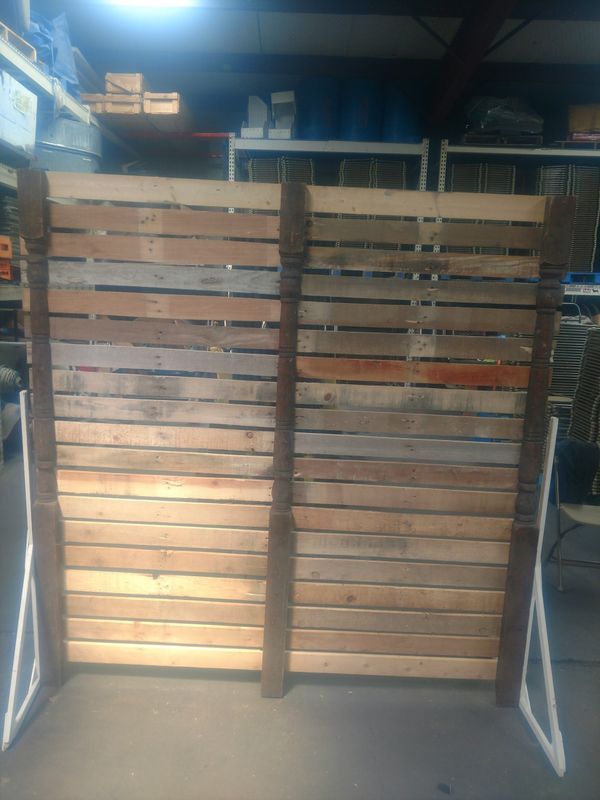 A wooden fence is sitting on the ground in a warehouse