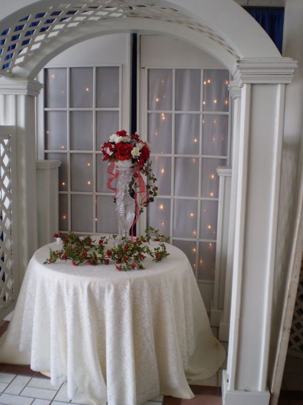 A table with a white table cloth and flowers on it