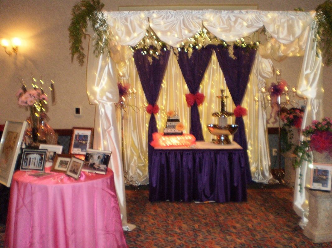 A table with a pink tablecloth and a cake on it