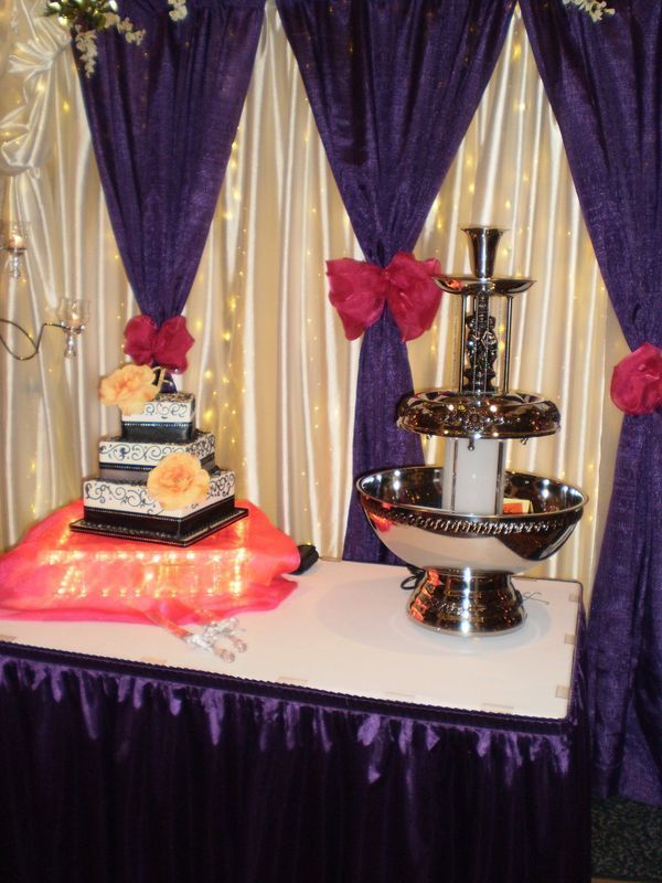 A table with a cake and a fountain on it