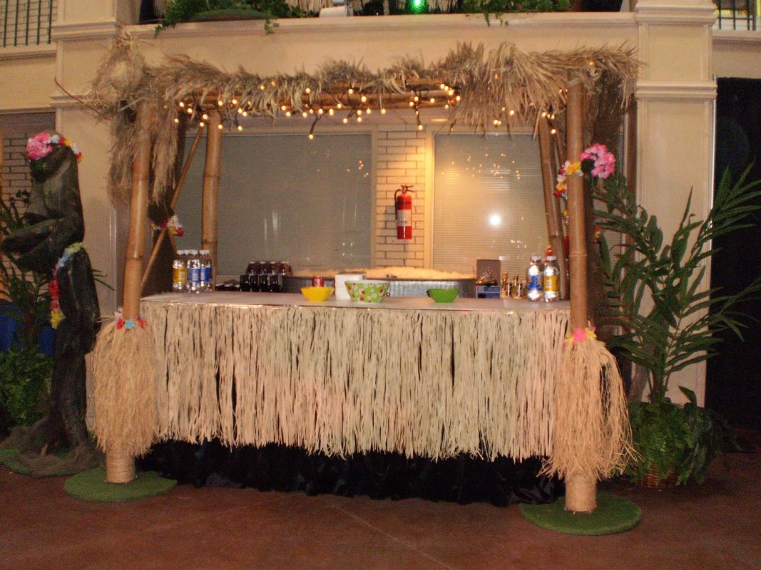 A table with a hawaiian theme and a fire extinguisher on it