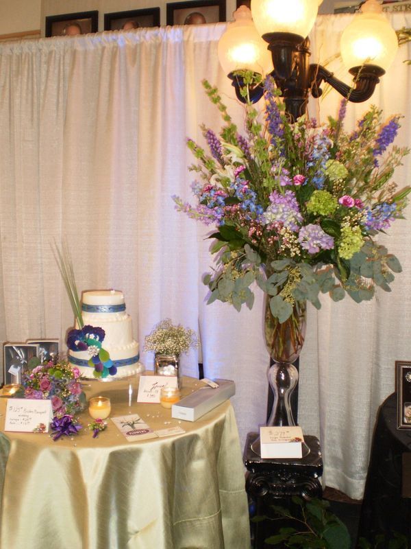 A table with flowers and a cake on it