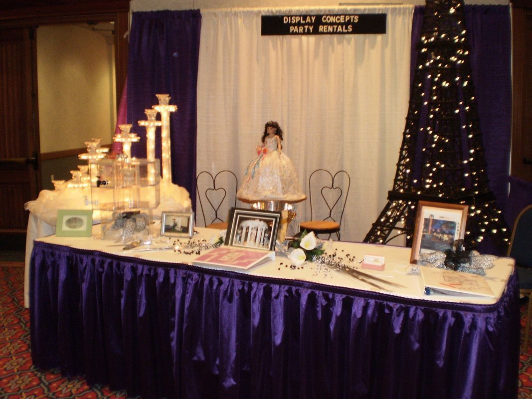 A table with a purple skirt and a sign that says happy birthday