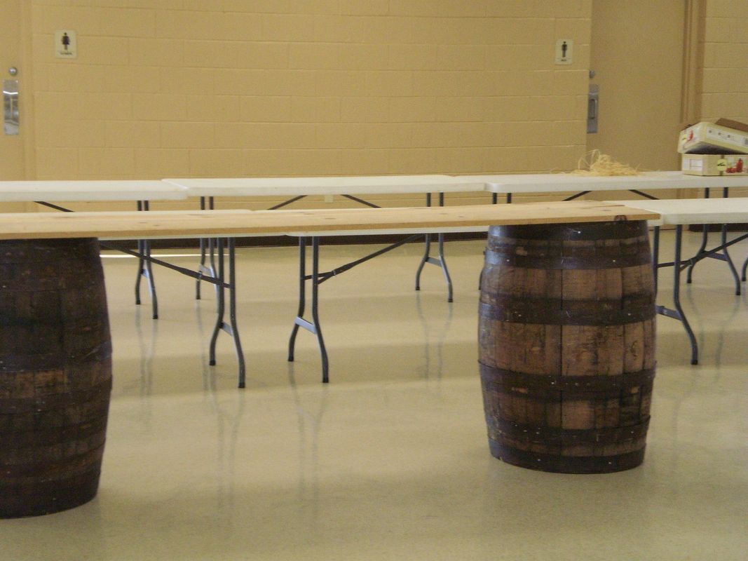 Two wooden barrels are sitting on a table in a room