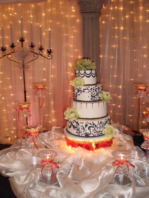 A wedding cake is sitting on a table with candles