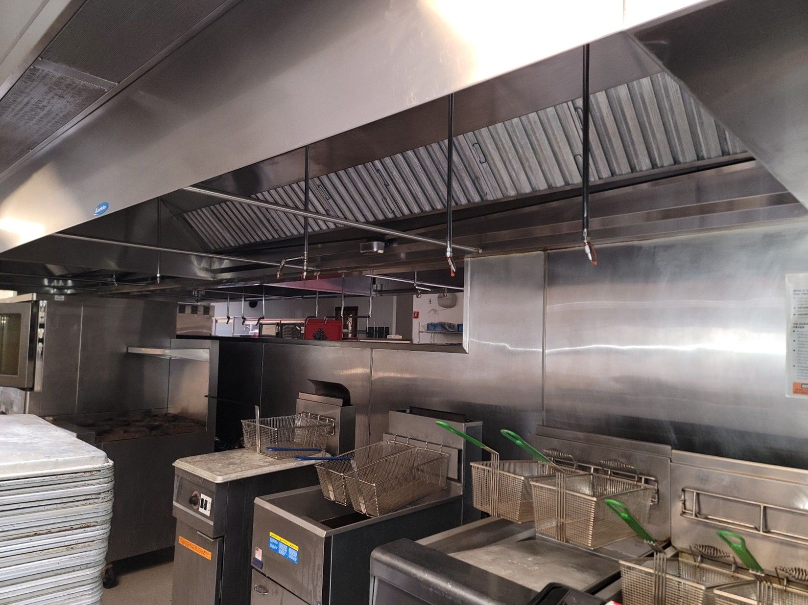 An extraction hood supply air return in a commercial kitchen.