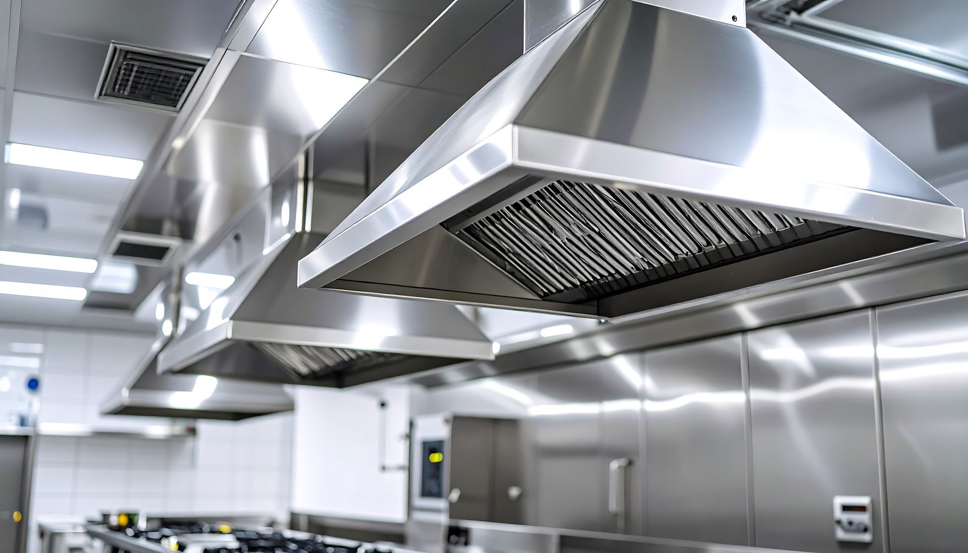 Modern commercial kitchen hood and ventilation system background.