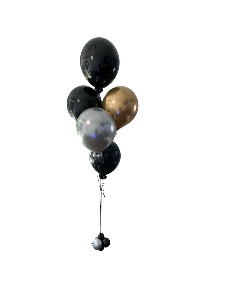 Bouquet of black, gold, and silver balloons tied together, isolated on white background.