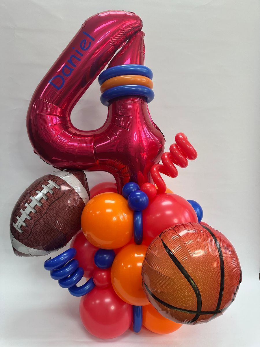 A balloon arrangement for a fourth birthday. Features a large, pink