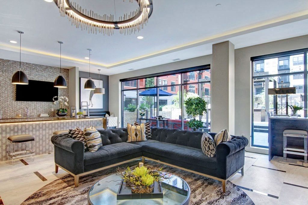 A living room with a large sectional couch and a coffee table.