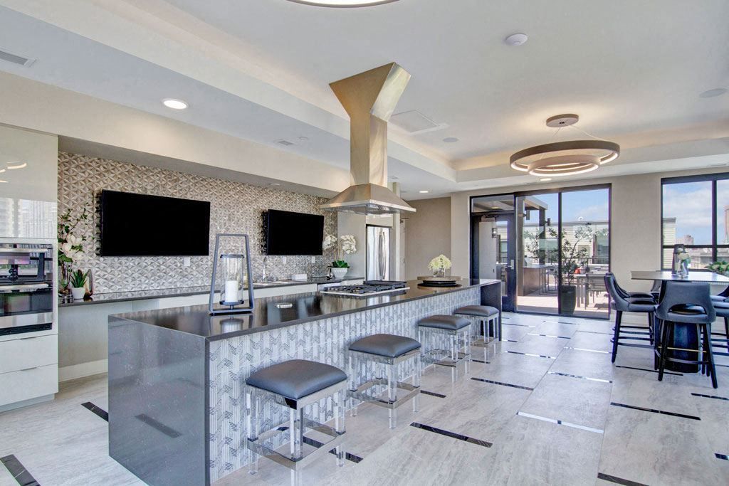 A large room with a kitchen and a dining area.