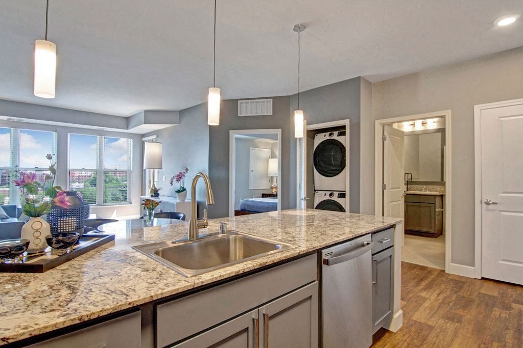 A kitchen with granite counter tops and stainless steel appliances.